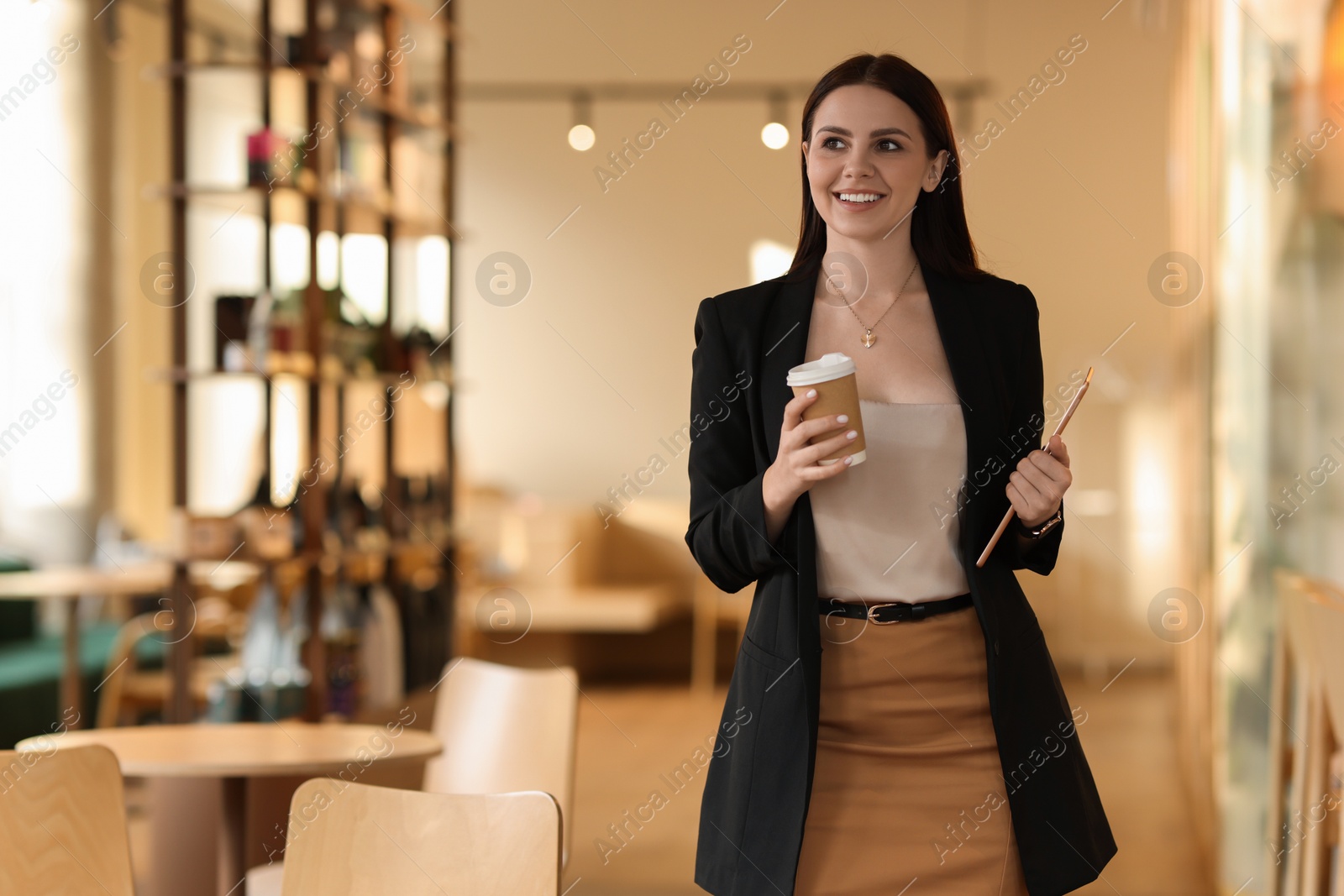 Photo of Woman in stylish formal suit with tablet and coffee indoors. Space for text