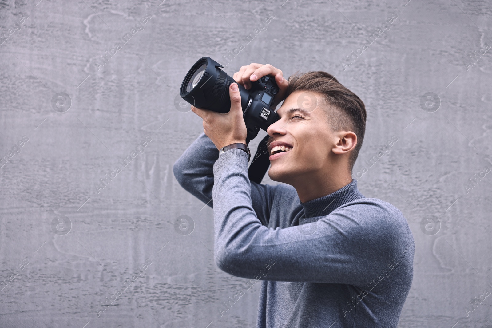 Photo of Professional photographer taking picture with camera outdoors