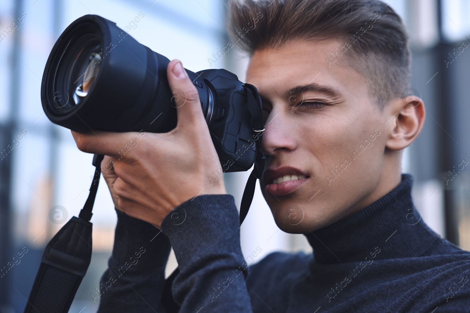 Photo of Professional photographer taking picture with camera outdoors