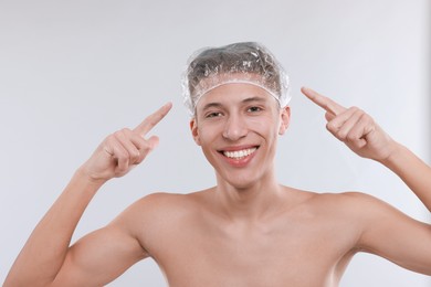 Photo of Man in shower cap on light grey background