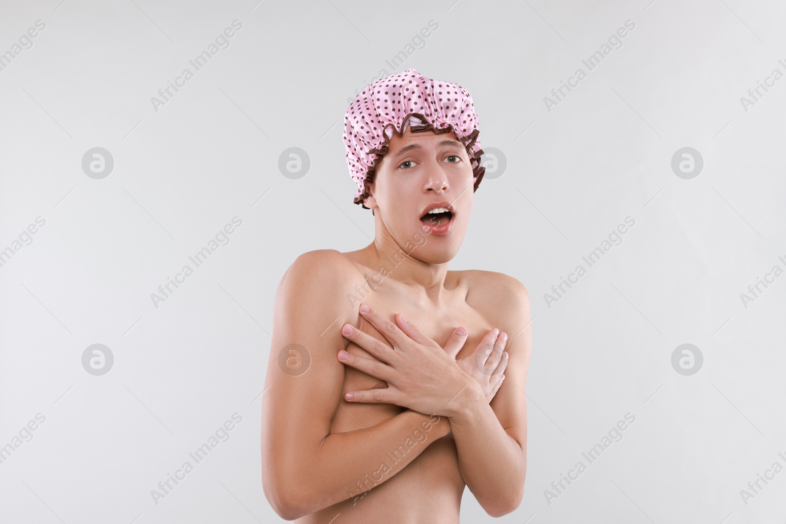 Photo of Man in shower cap on light grey background, space for text