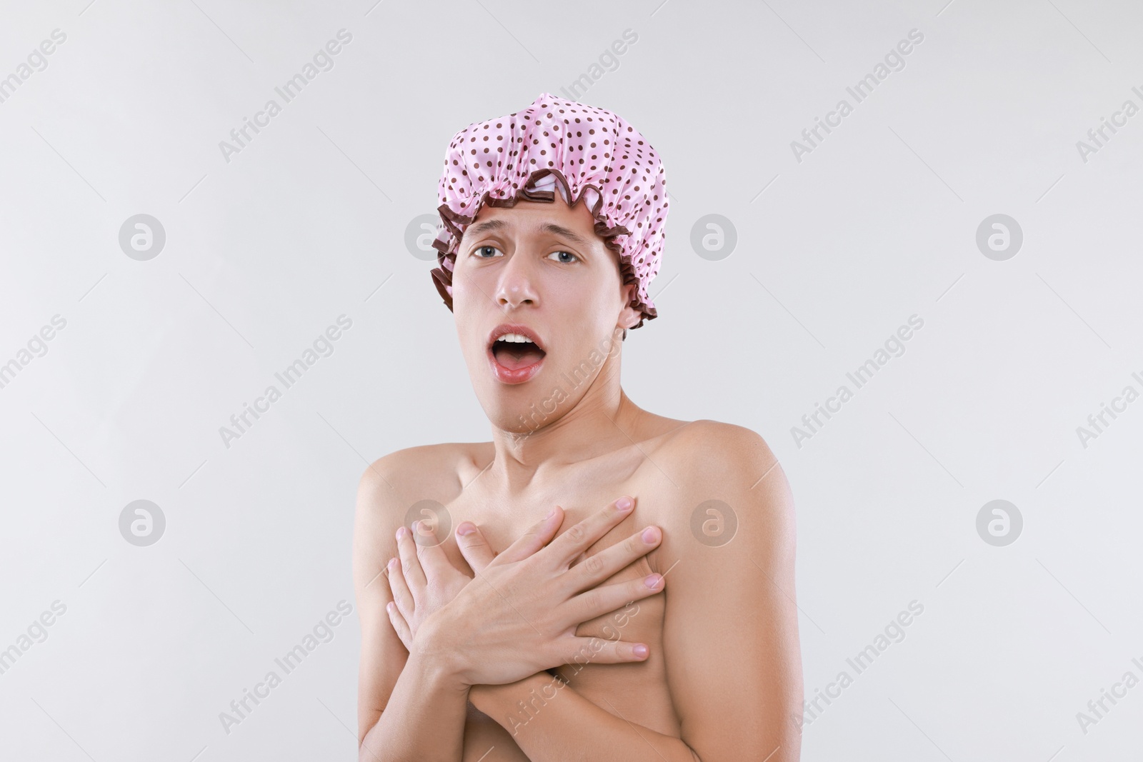 Photo of Man in shower cap on light grey background