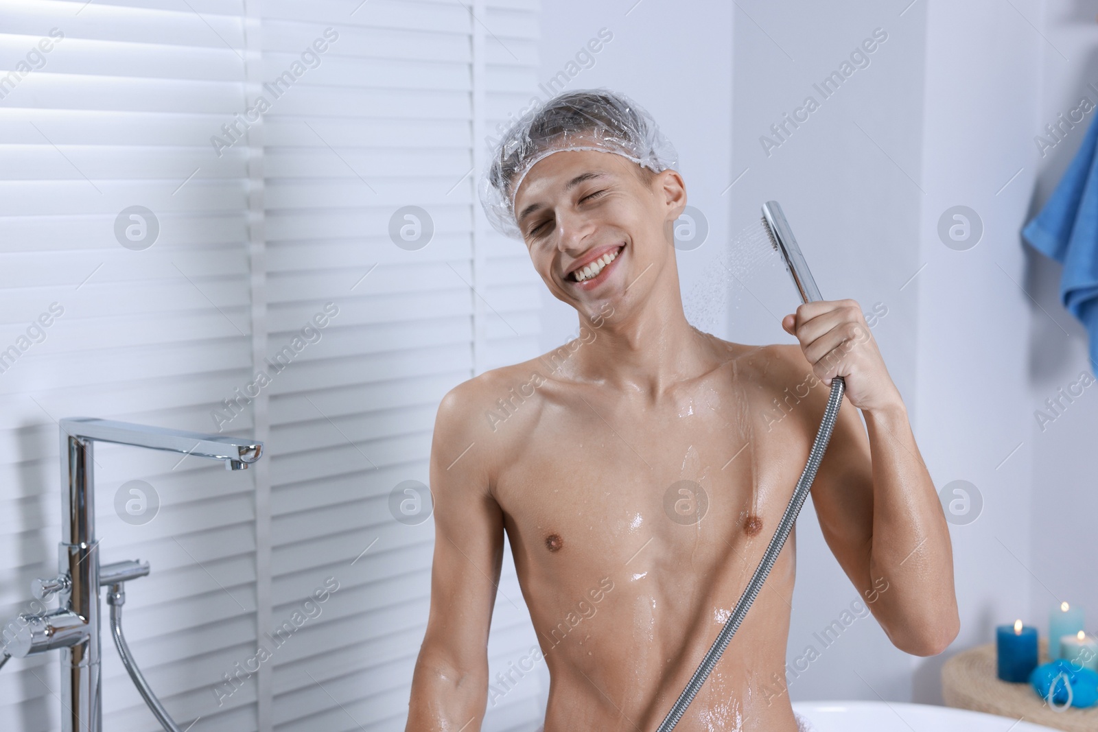 Photo of Man with cap taking shower in bathroom