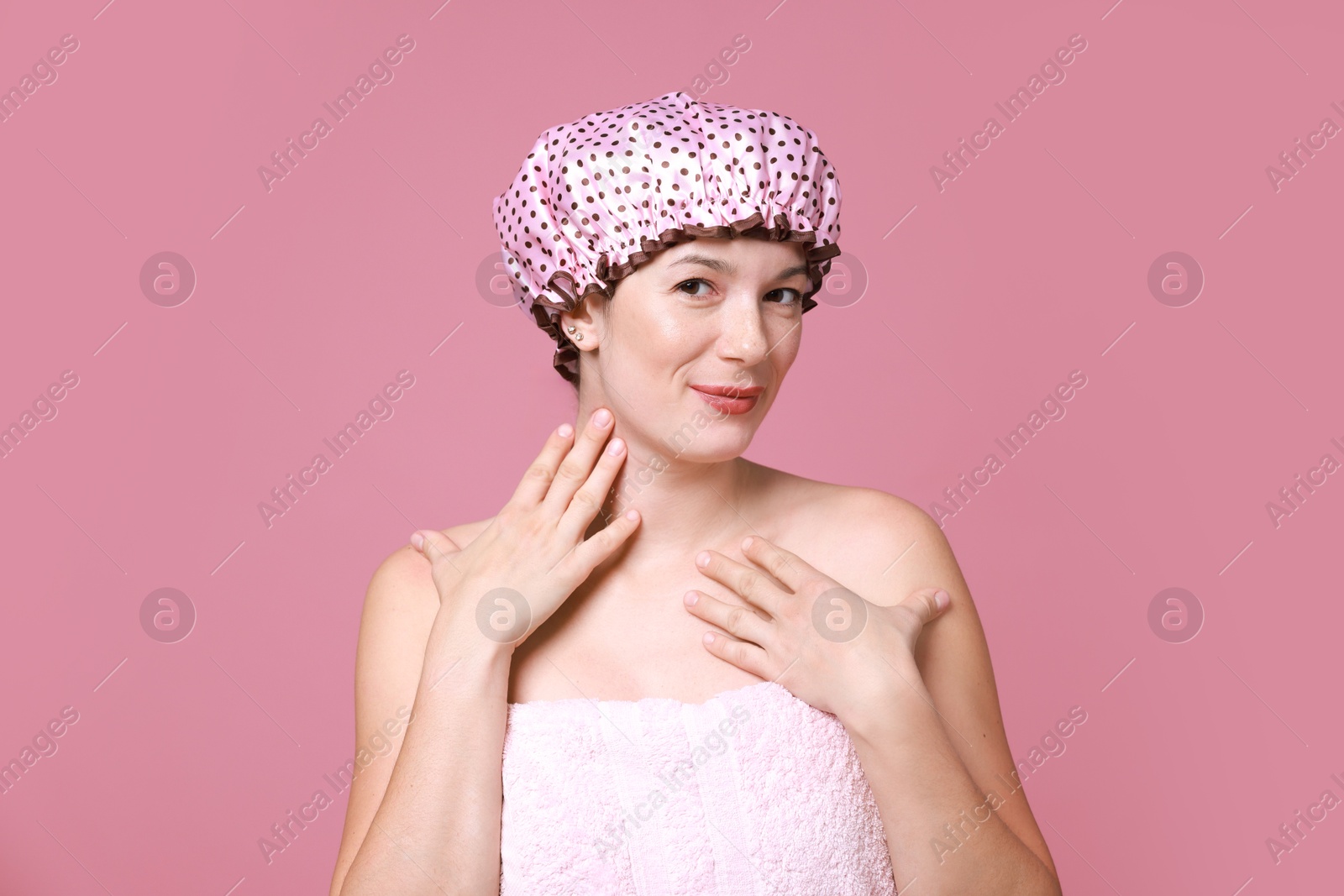 Photo of Woman in shower cap on pink background