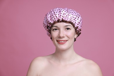 Photo of Woman in shower cap on pink background