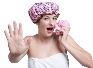 Photo of Woman with shower cap and mesh sponge making stop gesture on white background