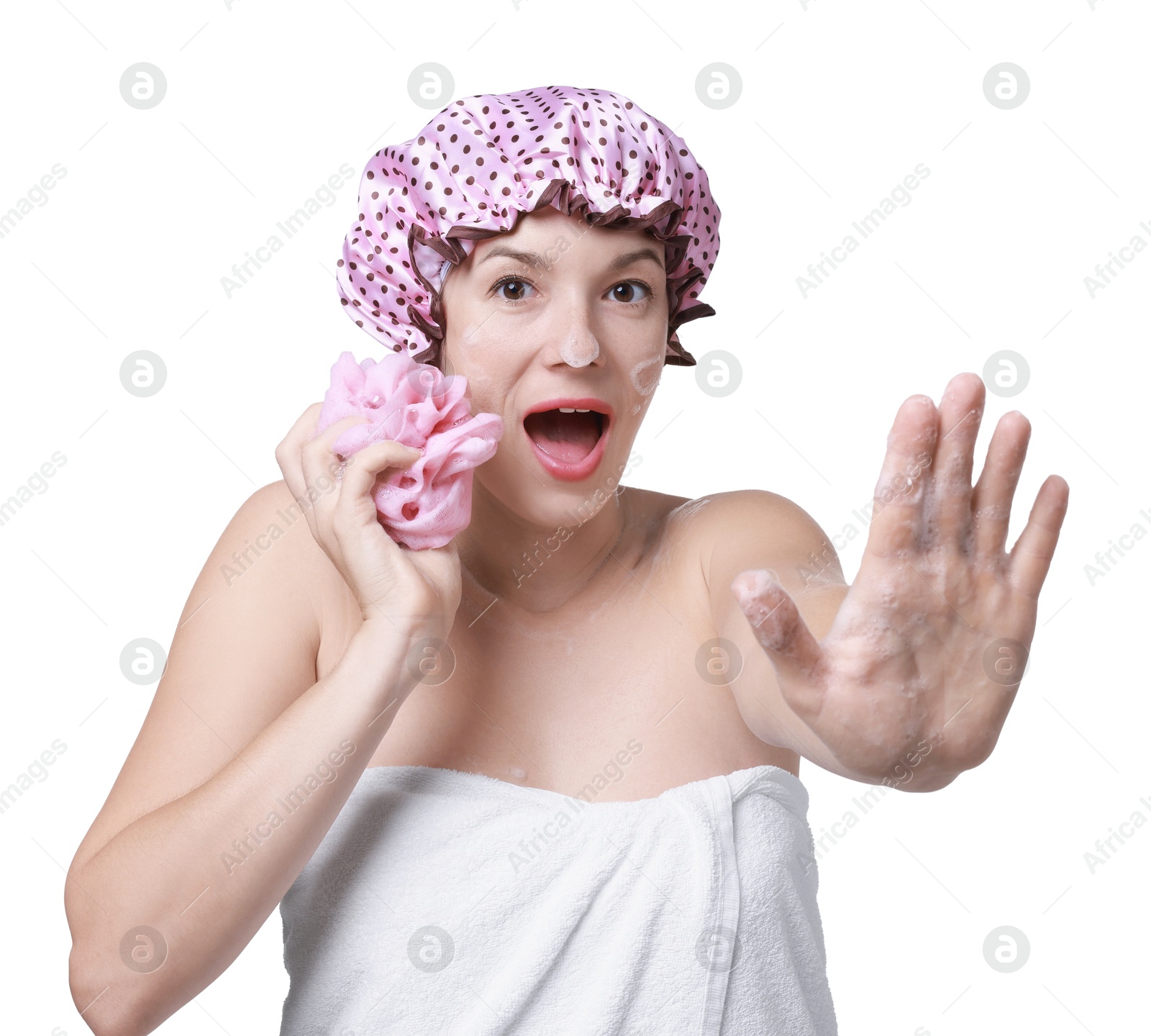 Photo of Woman with shower cap and mesh sponge making stop gesture on white background