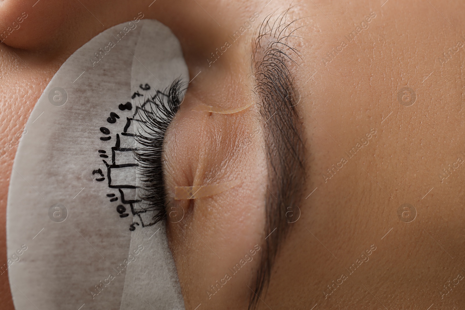 Photo of Woman with under eye patch mapped for lash extensions procedure, closeup