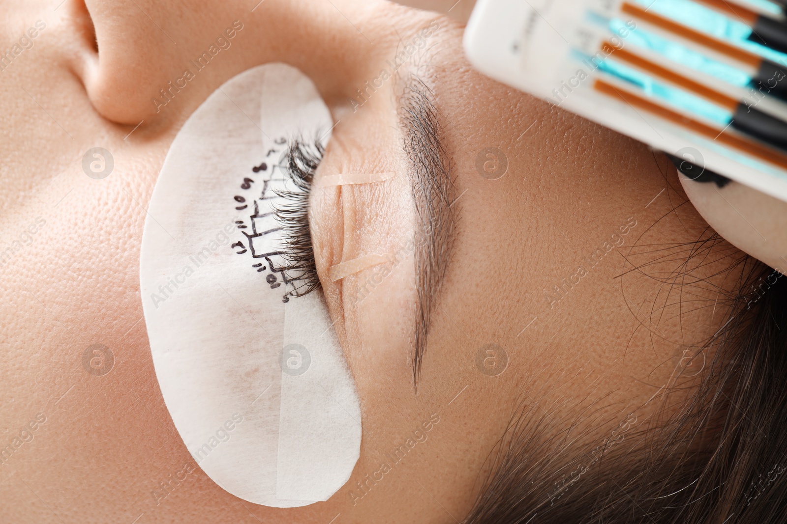 Photo of Woman with under eye patch mapped for lash extensions procedure, closeup