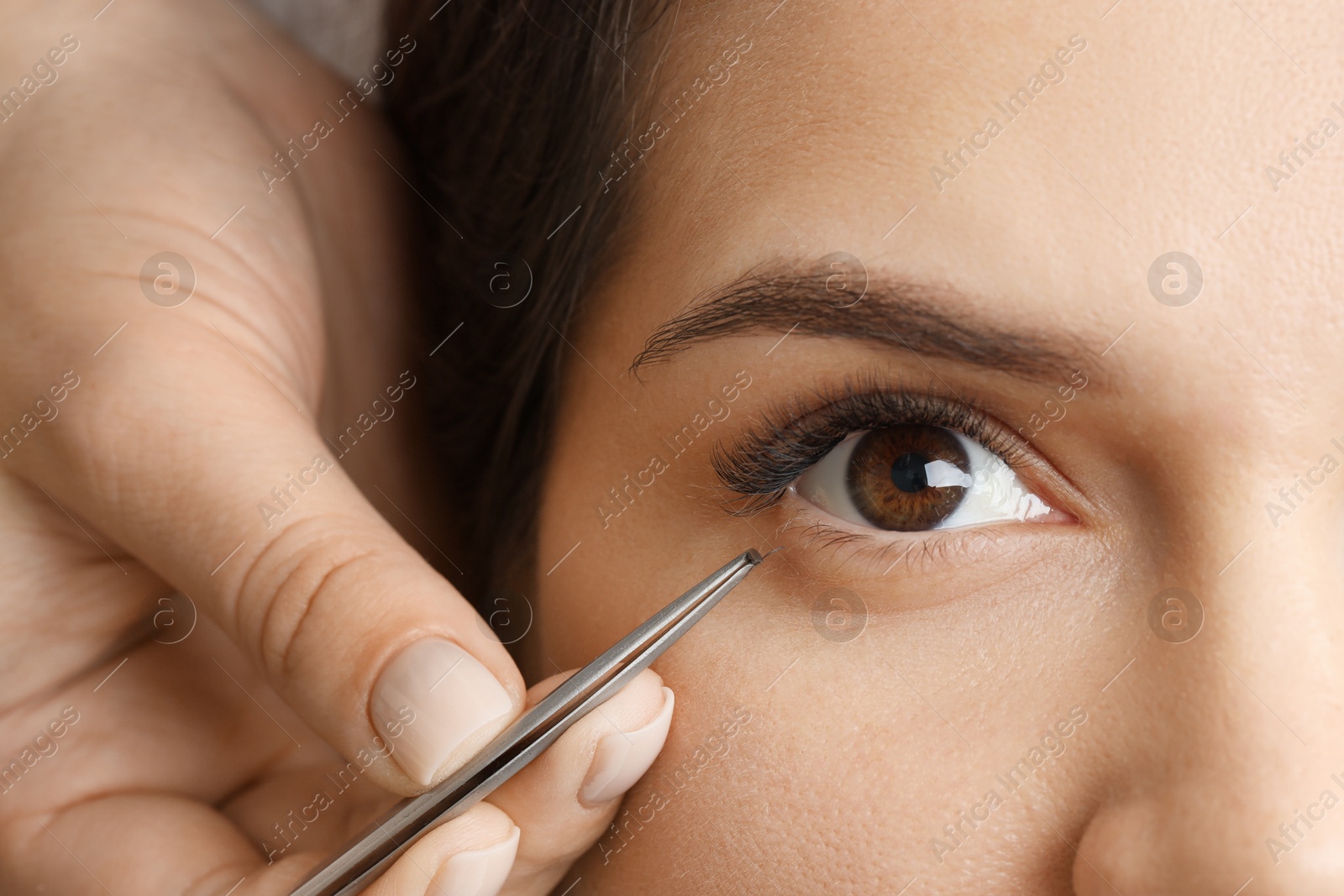 Photo of Woman undergoing lash extensions procedure, top view