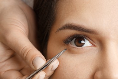 Woman undergoing lash extensions procedure, top view