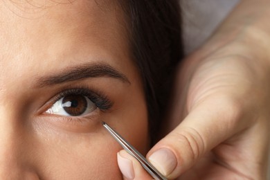 Photo of Woman undergoing lash extensions procedure, top view