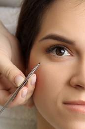 Photo of Woman undergoing lash extensions procedure, top view