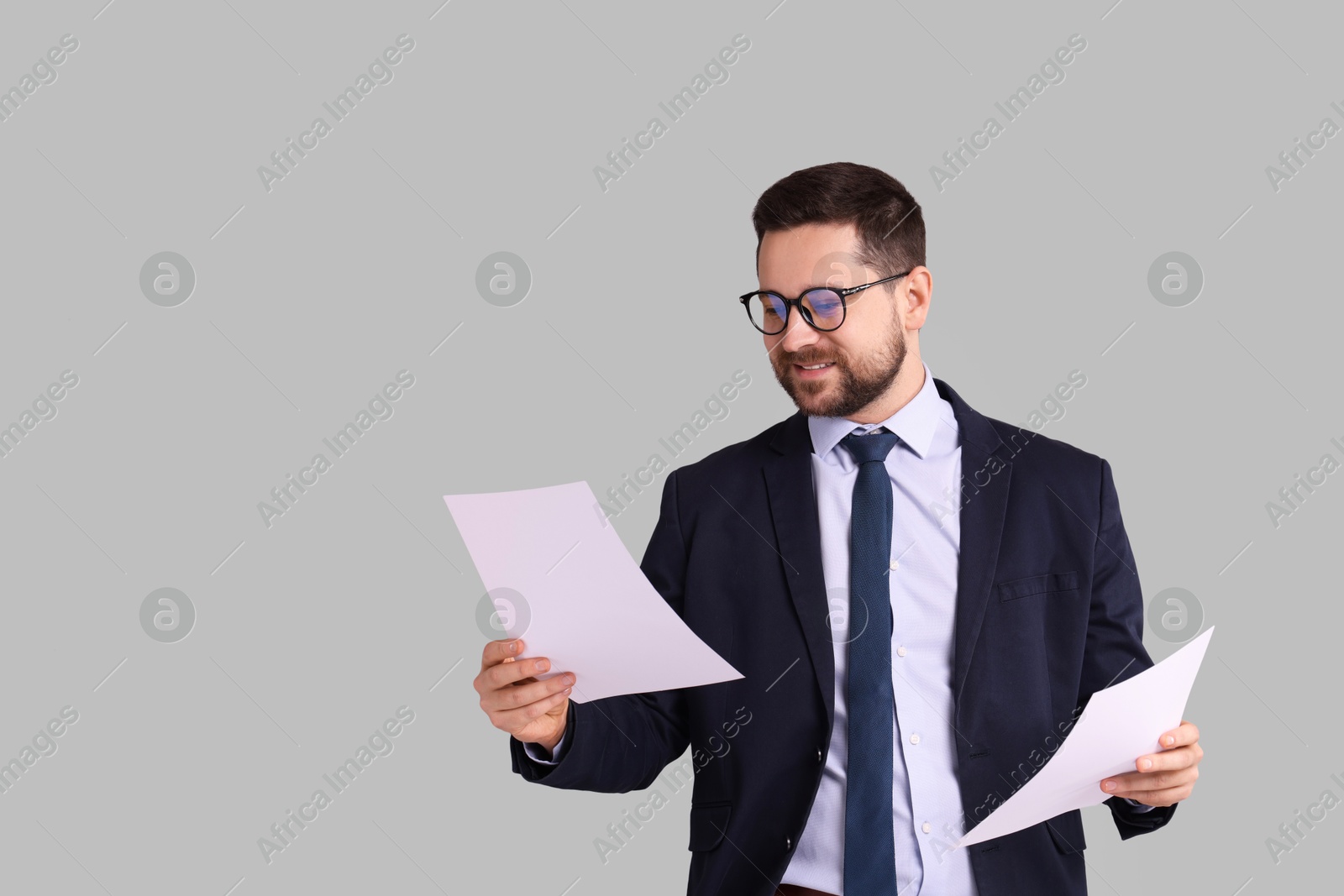 Photo of Portrait of banker with documents on grey background, space for text