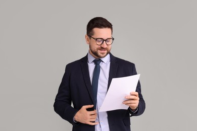 Photo of Portrait of banker with document on grey background