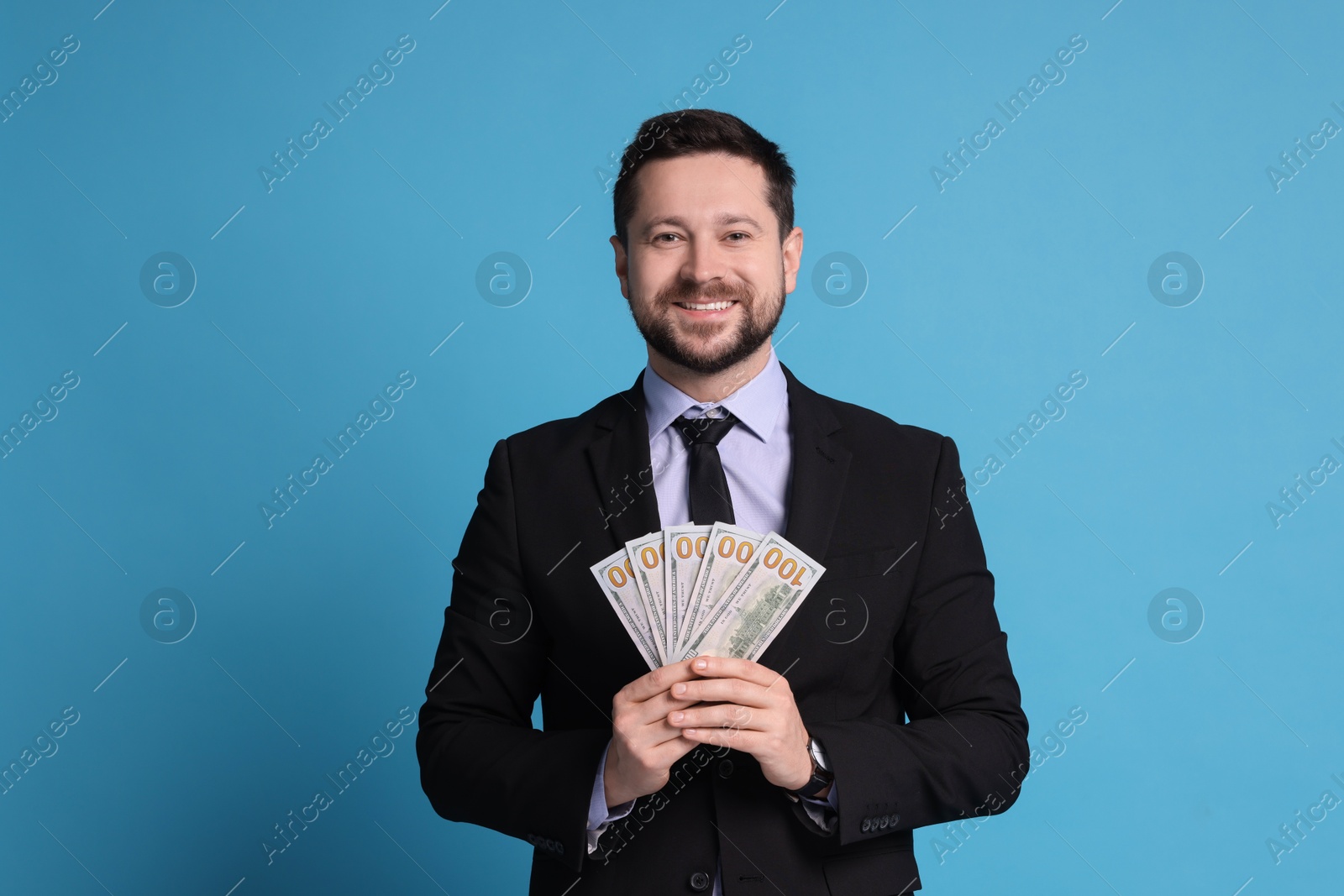 Photo of Banker with dollar banknotes on light blue background