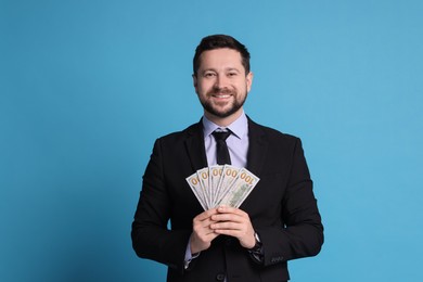 Photo of Banker with dollar banknotes on light blue background