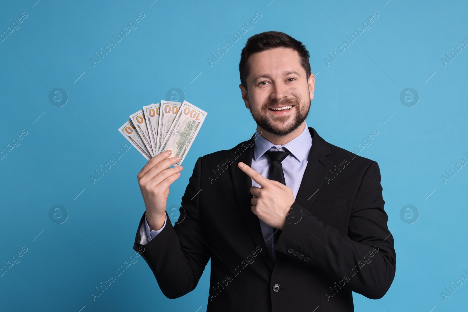 Photo of Banker with dollar banknotes on light blue background