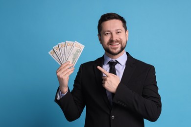 Banker with dollar banknotes on light blue background