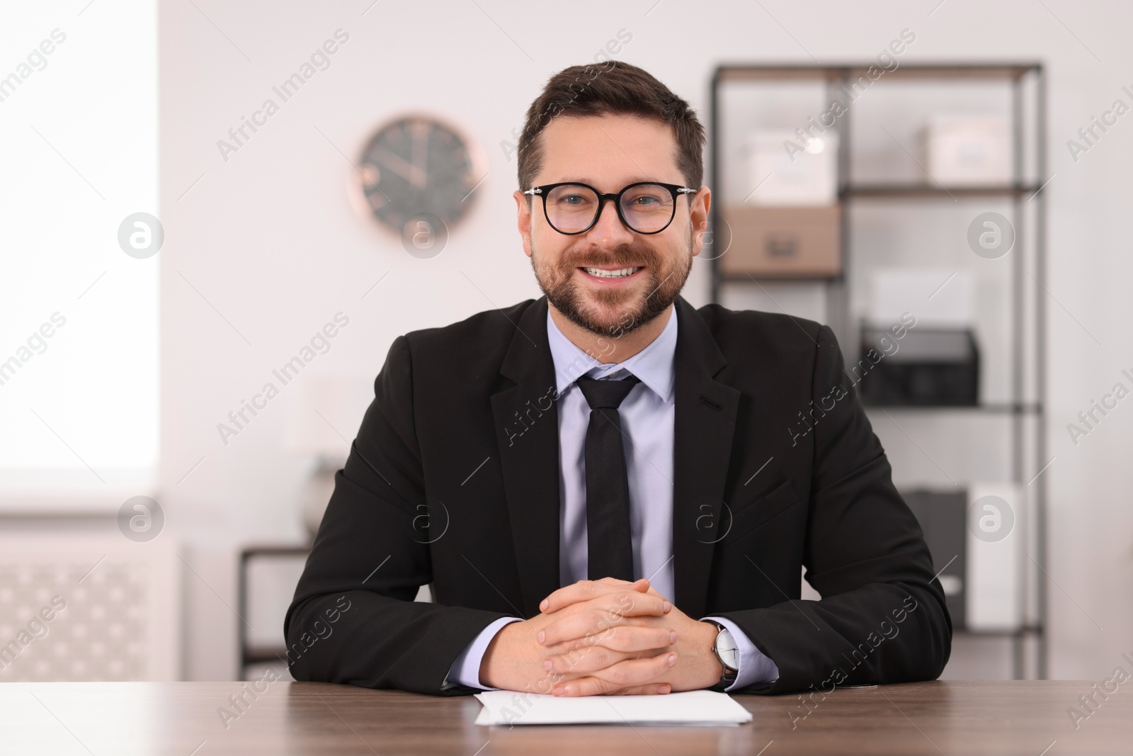 Photo of Portrait of banker at table in office