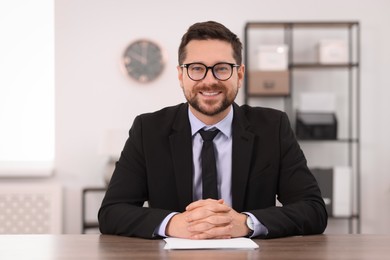 Portrait of banker at table in office