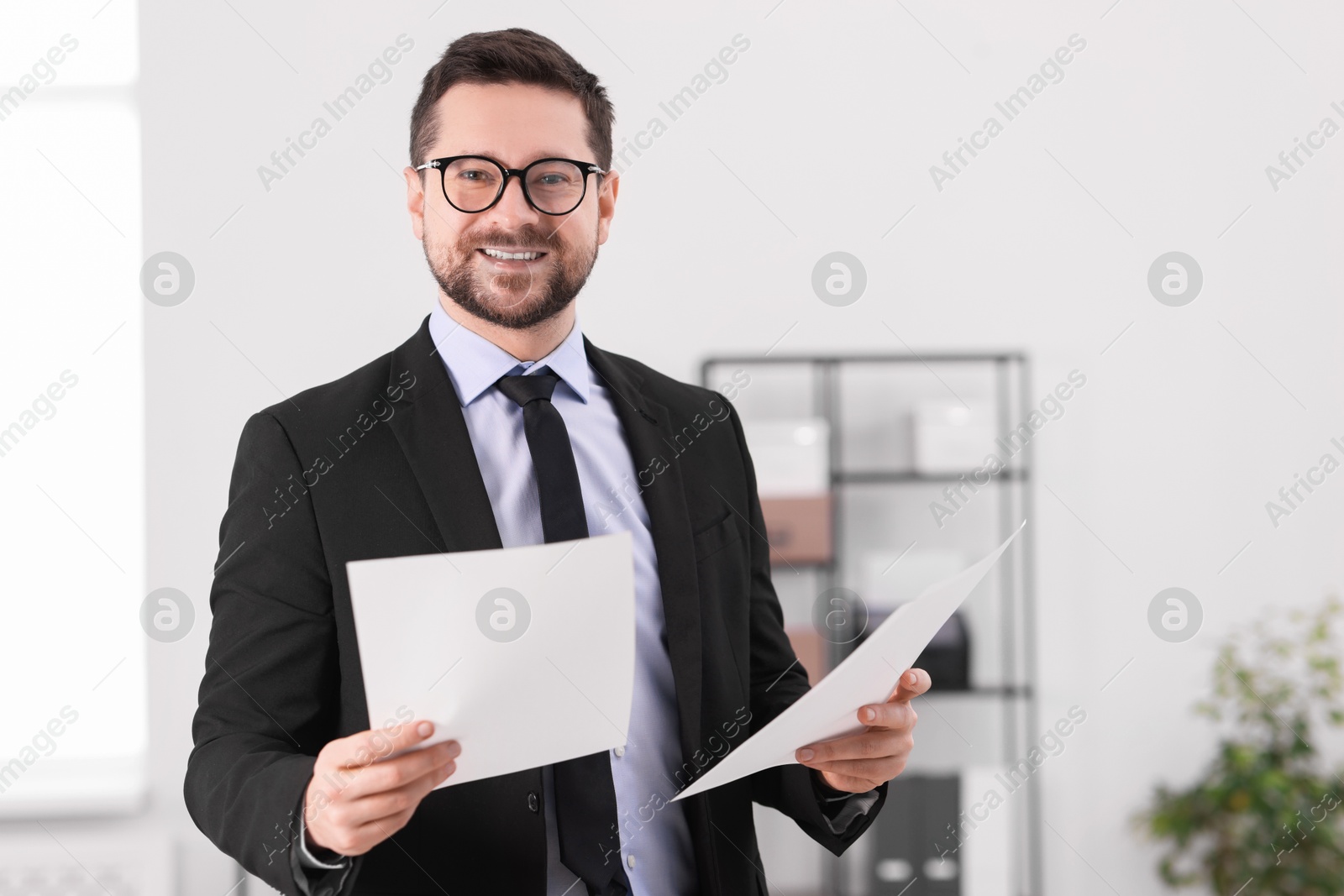 Photo of Portrait of banker with documents in office. Space for text