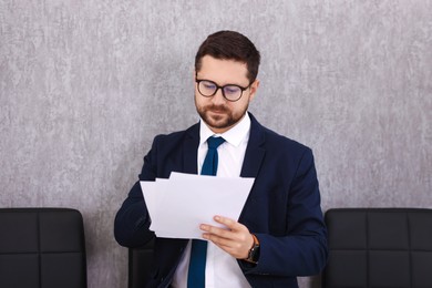 Photo of Portrait of banker with documents in office