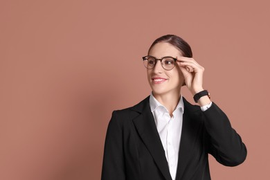 Photo of Portrait of banker in glasses on brown background, space for text