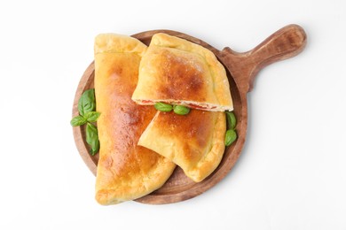 Photo of Tasty vegetarian calzones with tomato, cheese and basil isolated on white, top view