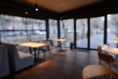 Photo of Blurred view of stylish restaurant with large windows