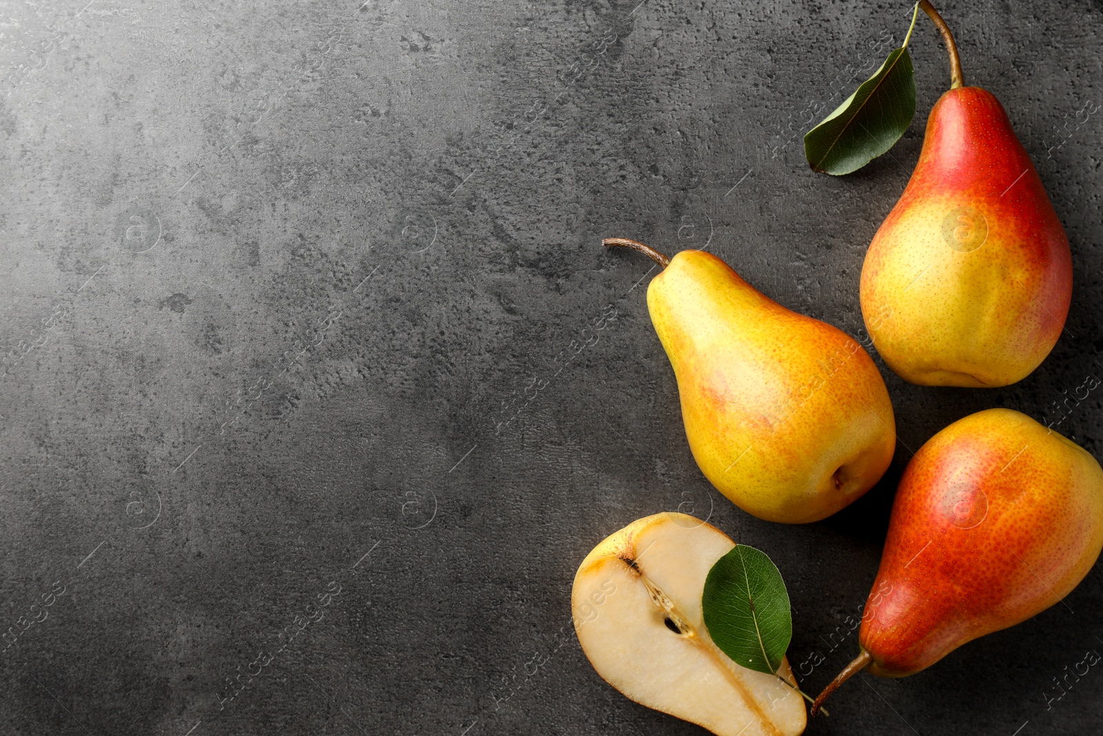 Photo of Ripe juicy pears on grey table, flat lay. Space for text