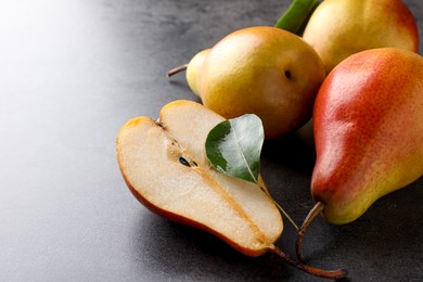 Photo of Ripe juicy pears on grey table, closeup