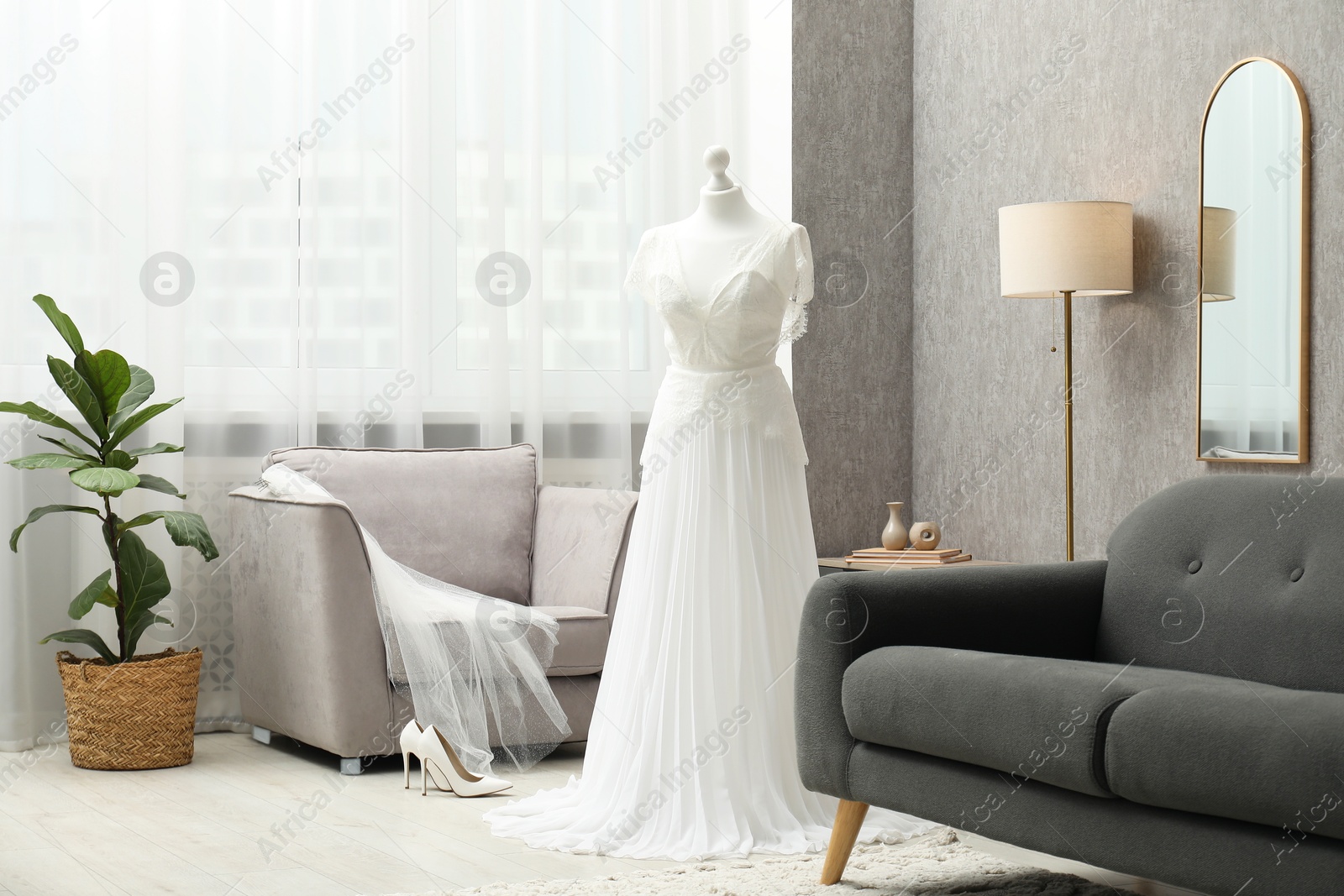 Photo of Beautiful wedding dress on mannequin and shoes in boutique