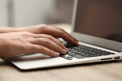 Photo of Businessman using laptop at table, closeup. Modern technology