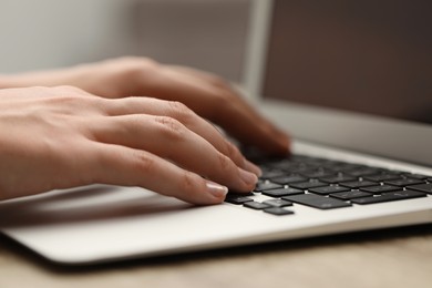 Photo of Businessman using laptop at table, closeup. Modern technology