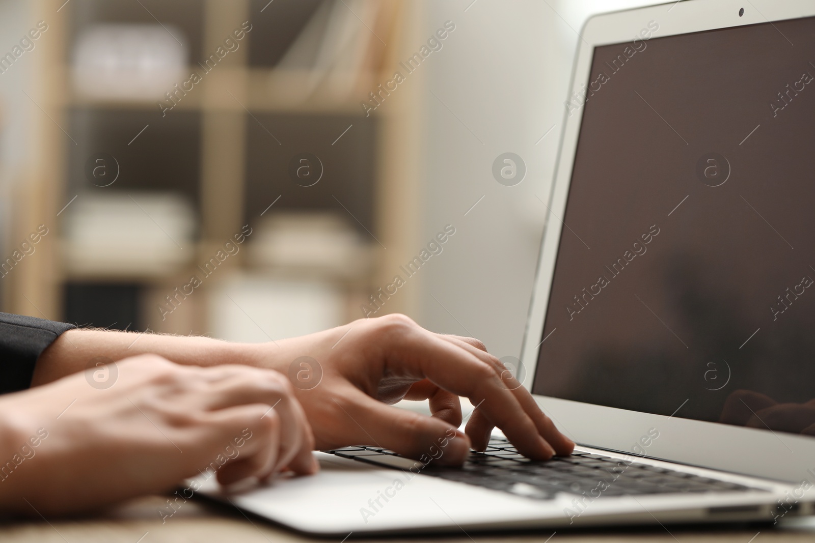 Photo of Businessman using laptop at table, closeup. Modern technology