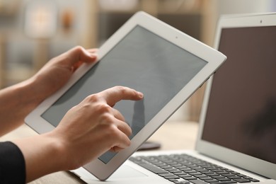 Photo of Businessman using tablet at table, closeup. Modern technology