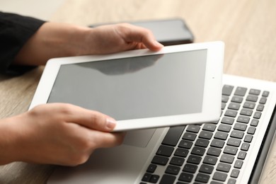 Photo of Businessman using tablet at table, closeup. Modern technology