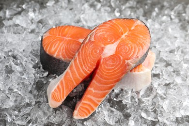 Photo of Fresh raw salmon steaks on ice pieces, closeup