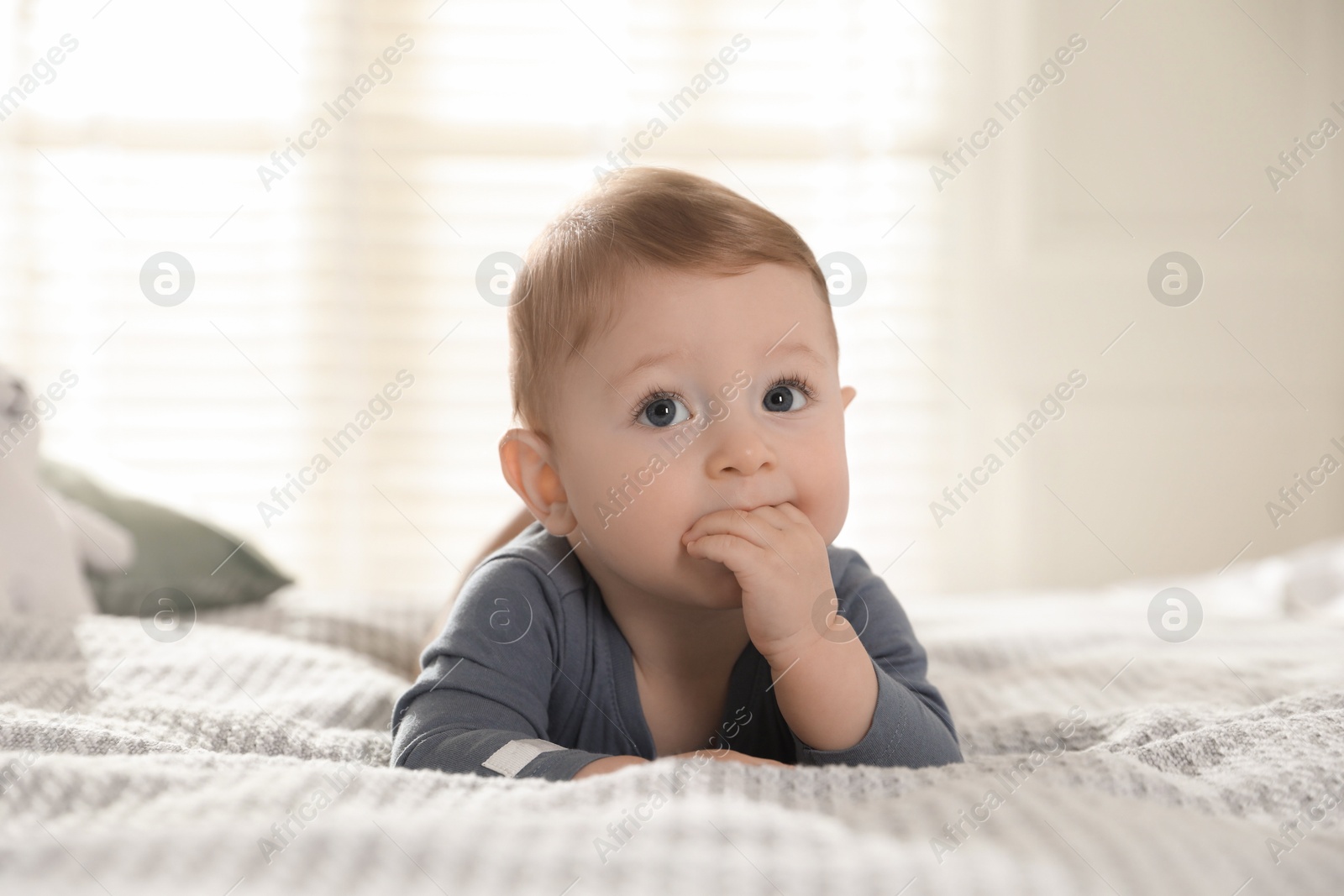 Photo of Cute little baby on bed at home