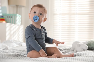 Photo of Cute little baby on bed at home