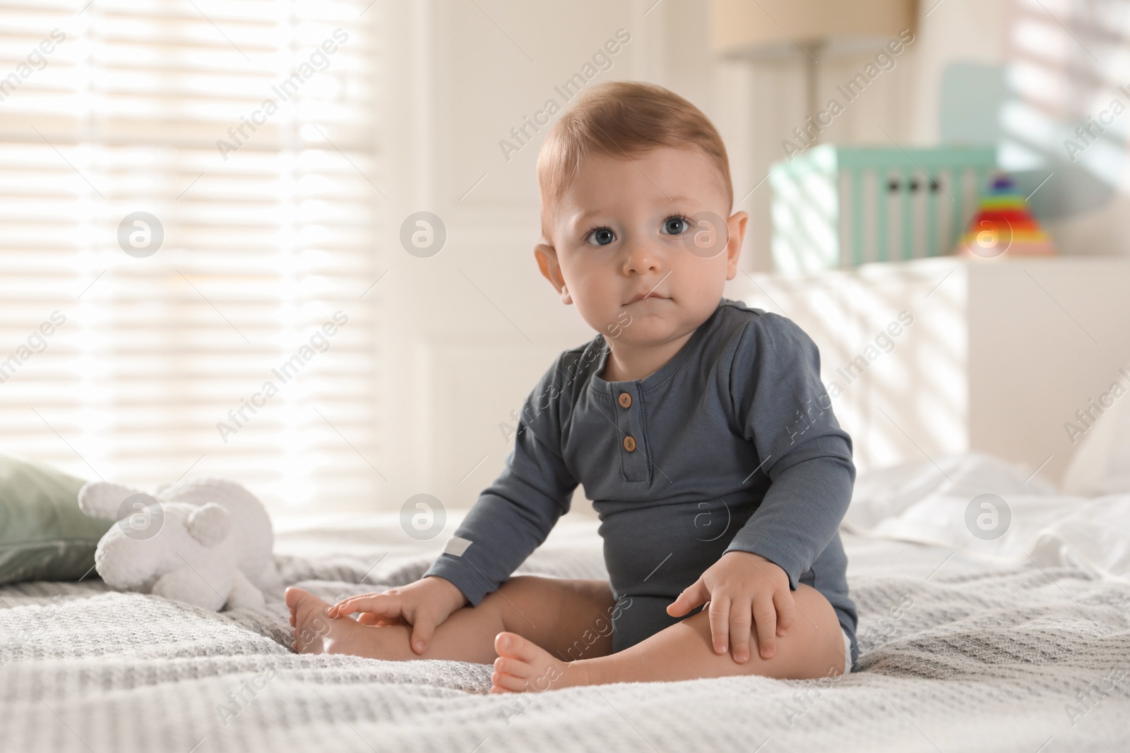 Photo of Cute little baby on bed at home