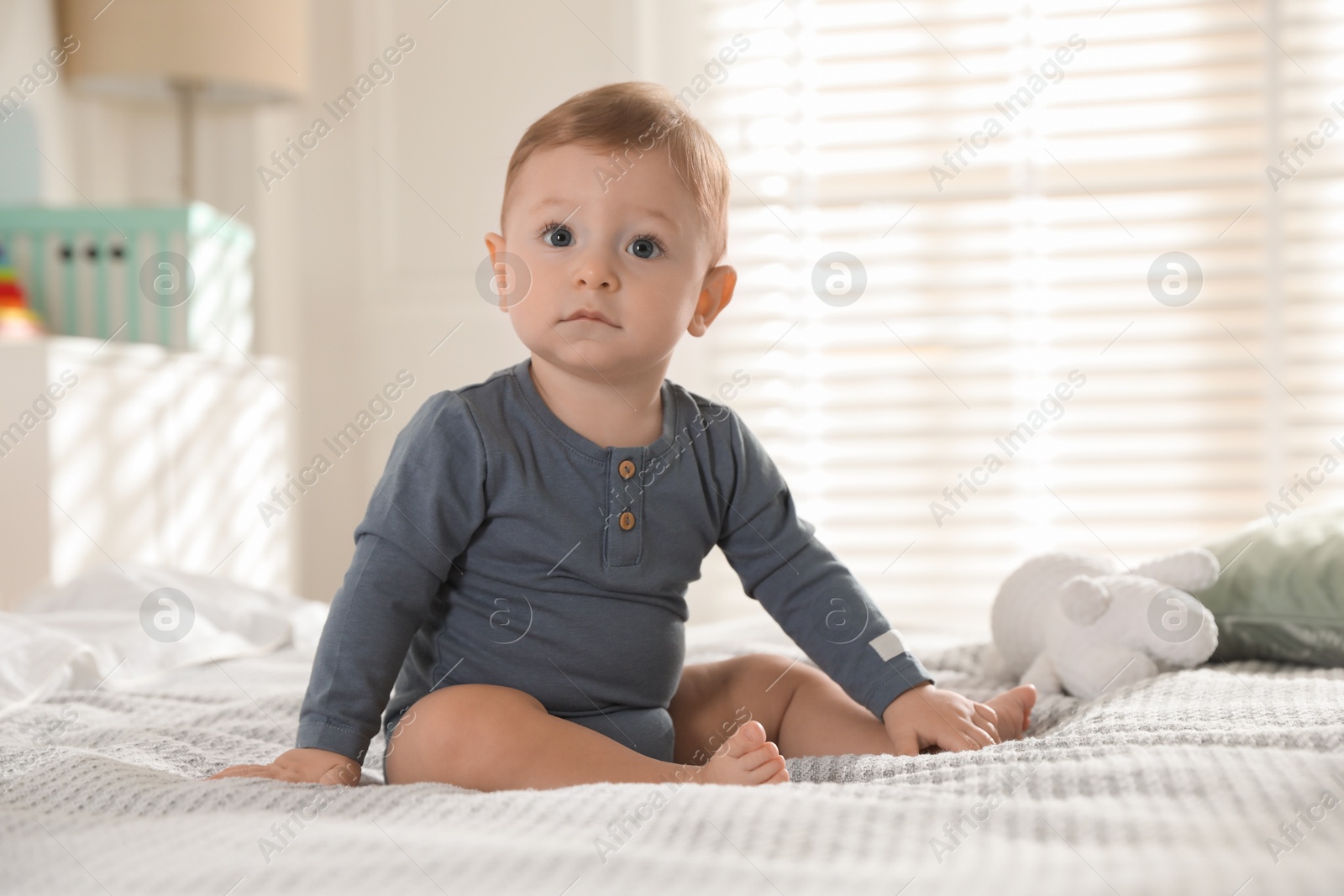 Photo of Cute little baby on bed at home