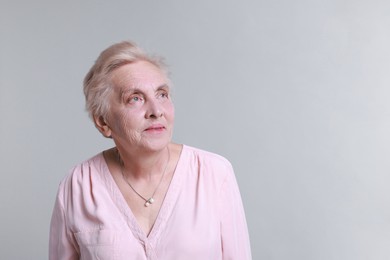 Photo of Portrait of senior woman on light background. Space for text