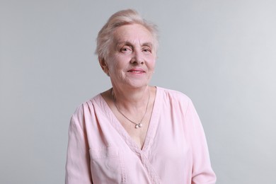 Photo of Portrait of senior woman on light background