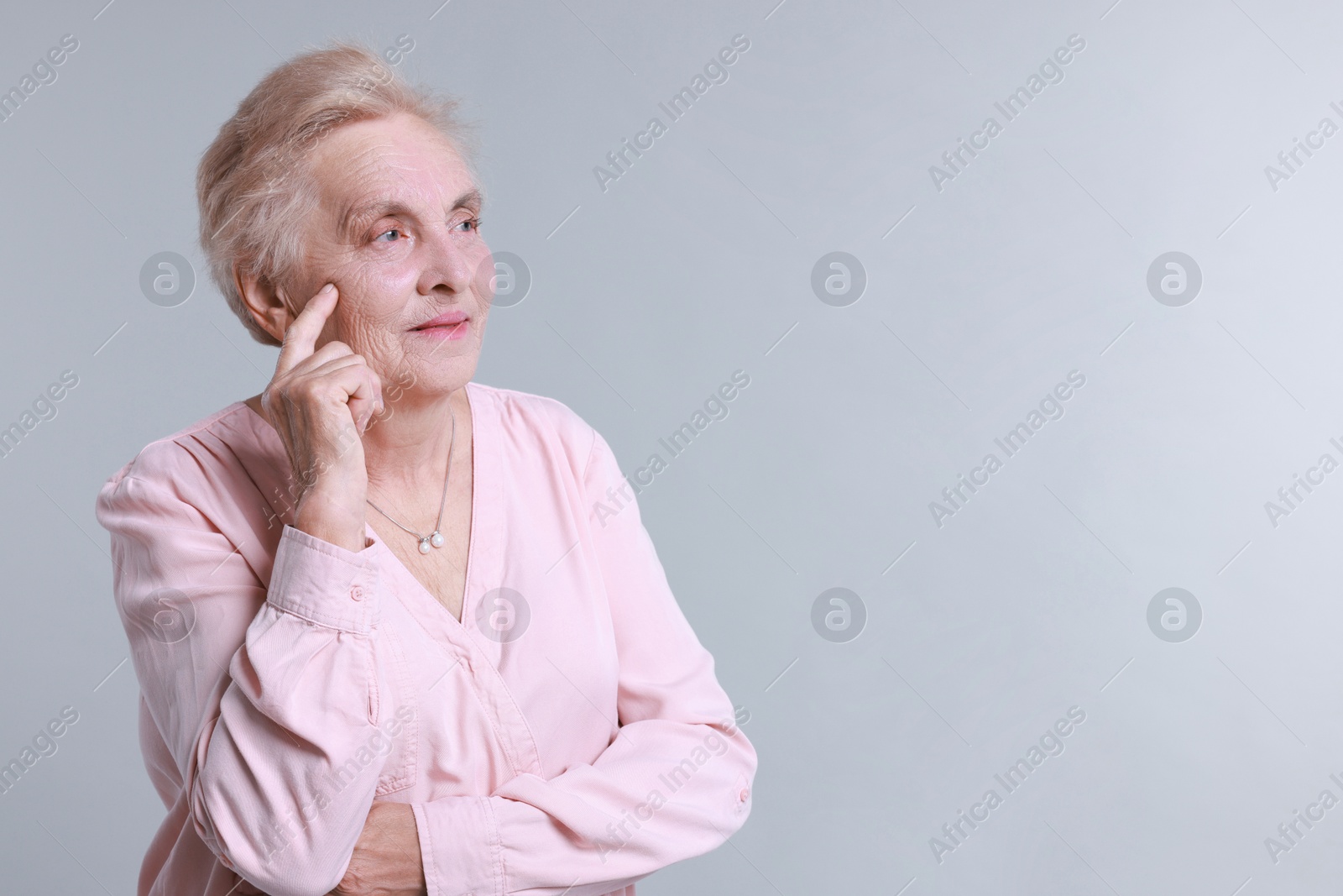 Photo of Portrait of senior woman on light background. Space for text