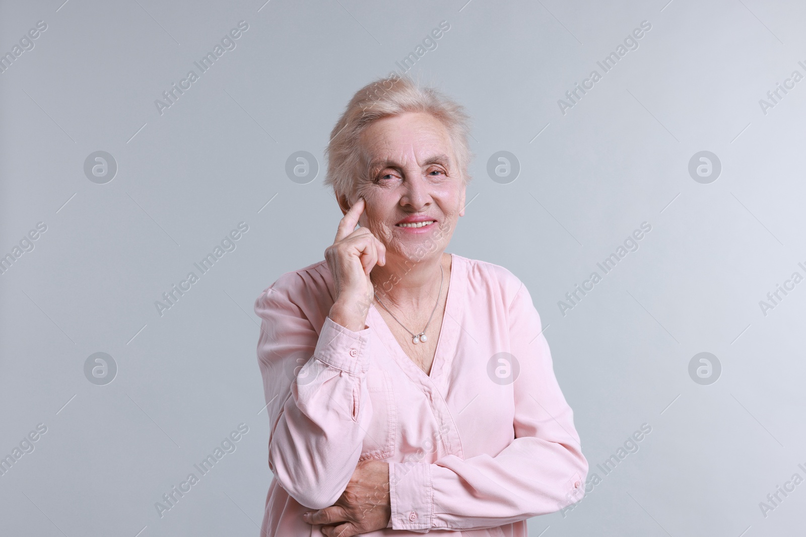 Photo of Portrait of senior woman on light background