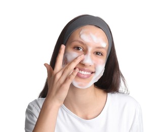 Photo of Teenage girl washing her face with cleanser on white background. Cosmetic product