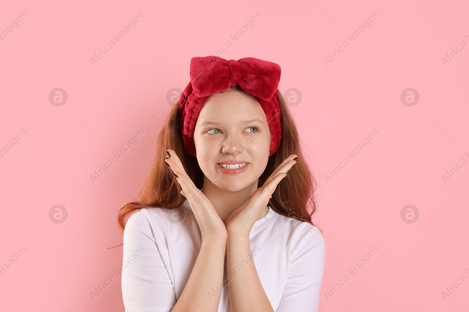 Photo of Portrait of teenage girl with headband on pink background