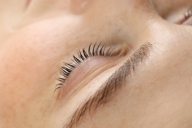 Photo of Beautiful woman after lash laminating and tinting procedure, closeup